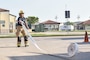 Aviation Boatswain’s Mate (Handling) 1st Class Stephen Andujar, assigned to Naval Support Activity (NSA) Naples Fire Department, rolls out a fire hose in preparation for a live fire training exercise on board NSA Naples’ Support Site, June 26, 2020.