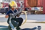 Aviation Boatswain’s Mate (Handling) 2nd Class Rhena Stephens, assigned to Naval Support Activity (NSA) Naples Fire Department, connects two fire hoses in preparation for a live fire training exercise on board NSA Naples’ Support Site, June 26, 2020.