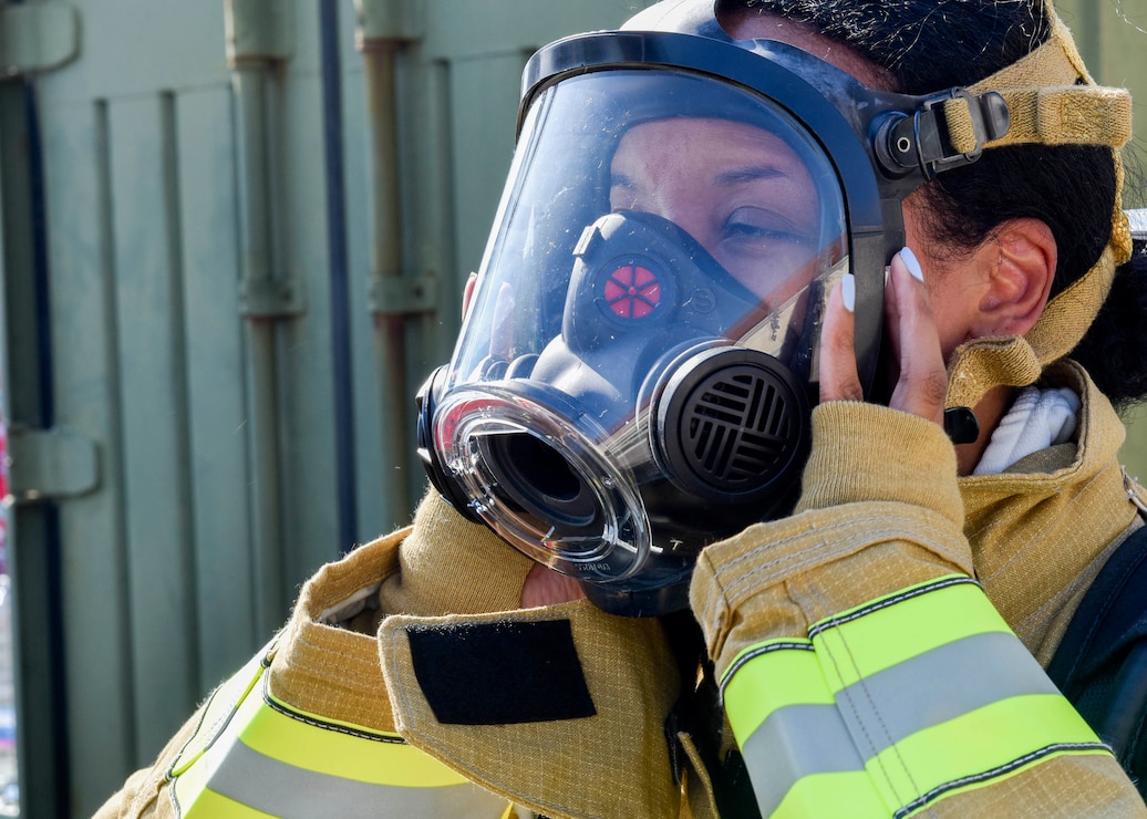 Morgan Gilliam, deputy public affairs officer for Commander, Navy Region Europe, Africa, Central, dons a face mask in preparation for a live fire training exercise on board Naval Support Activity (NSA) Naples’ Support Site, June 26, 2020.