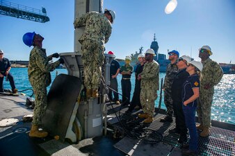 U.S. and Australian sailors load ordnance aboard  USS Springfield (SSN 761) in Perth, Australia.