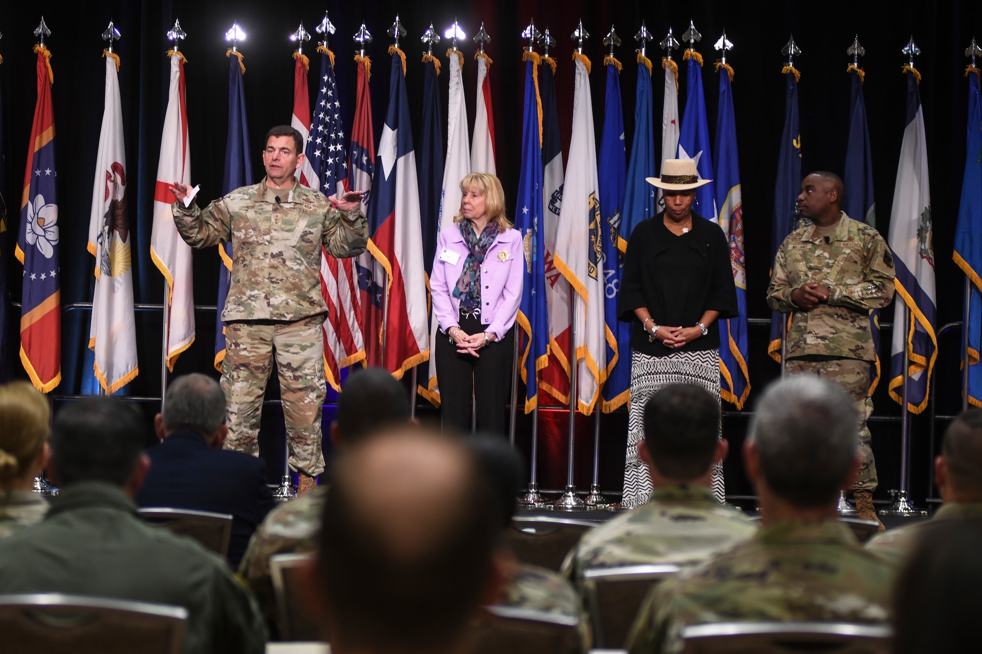 From left, U.S. Air Force Lt. Gen. Michael A. Loh, director, Air National Guard (ANG), Mrs. Dianne Loh, Mrs. Gwendolyn Williams, and Command Chief Master Sgt. Maurice L. Williams, command chief, ANG, take part in the opening ceremony of the 2022 Air National Guard Senior Leader Conference (ASLC) in Dallas, Texas, April 19, 2022. ASLC joined together senior leaders and commanders from across the 90 wings, 50 states, 3 territories and the District of Columbia to exchange ideas and provide input on critical matters impacting the future of the ANG and Air Force. (U.S. Air National Guard photo by Tech. Sgt. Morgan R. Whitehouse)