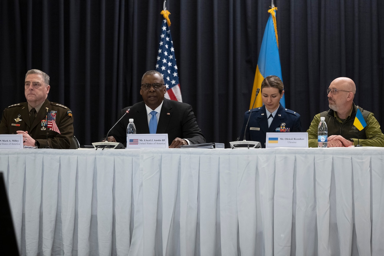 Secretary of Defense Lloyd J. Austin III sits at a table with Army Gen. Mark A. Milley and other officials.