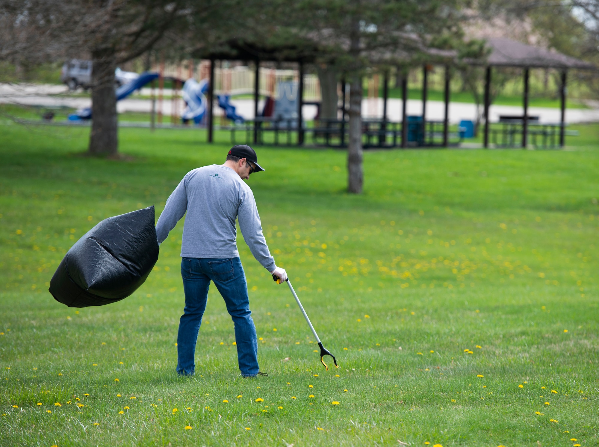 Michael Vaughn, 88th Communications Group project manager, participates in an Earth Day event hosted by Wright-Patterson Air Force Base the City of Fairborn and the Beavercreek Wetlands Association at the Community Park in, Fairborn, Ohio, April 22, 2022. During the event volunteers picked up trash and debris in order to clean up the park. (U.S. Air Force photo by Wesley Farnsworth)