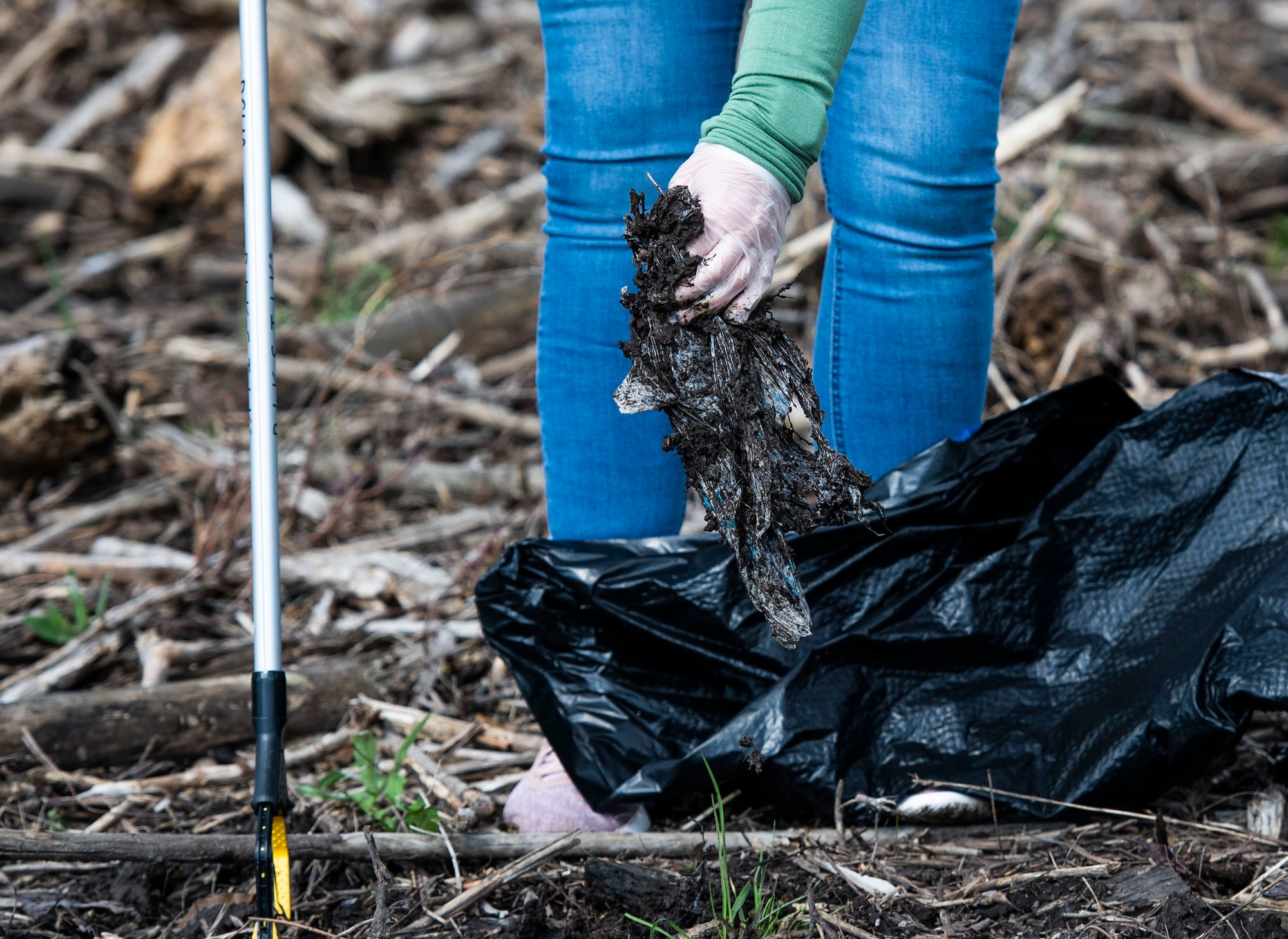 A member of Team Wright-Patt participate in an Earth Day event hosted by Wright-Patterson Air Force Base the City of Fairborn and the Beavercreek Wetlands Association at the Community Park in, Fairborn, Ohio, April 22, 2022. During the event volunteers picked up trash and debris in order to clean up the park. (U.S. Air Force photo by Wesley Farnsworth)