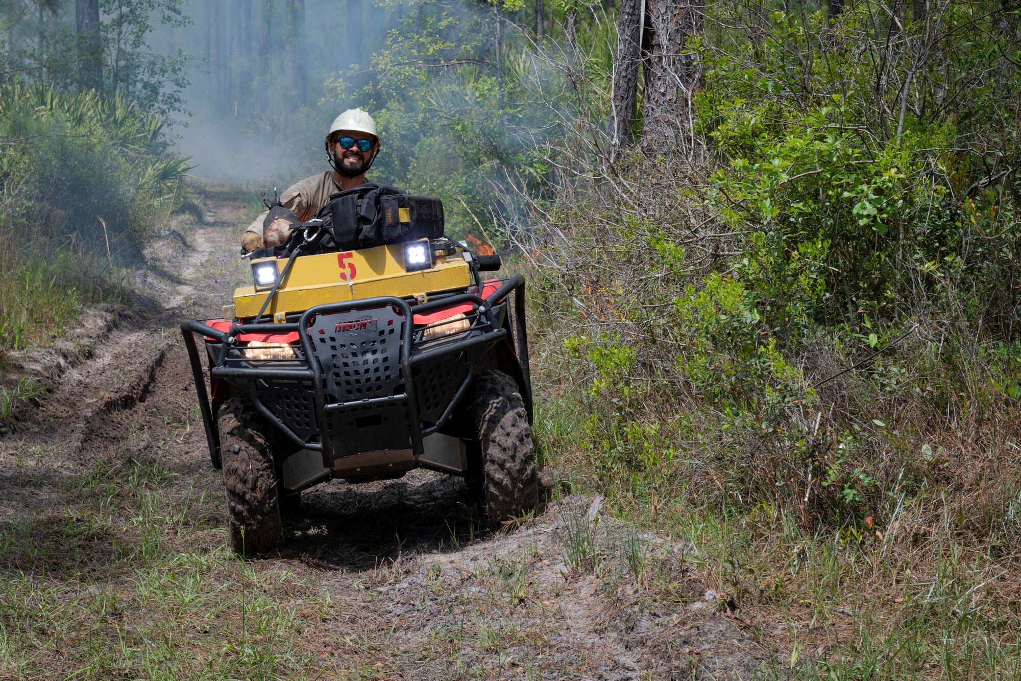 Photo of an Airman surveying a trail