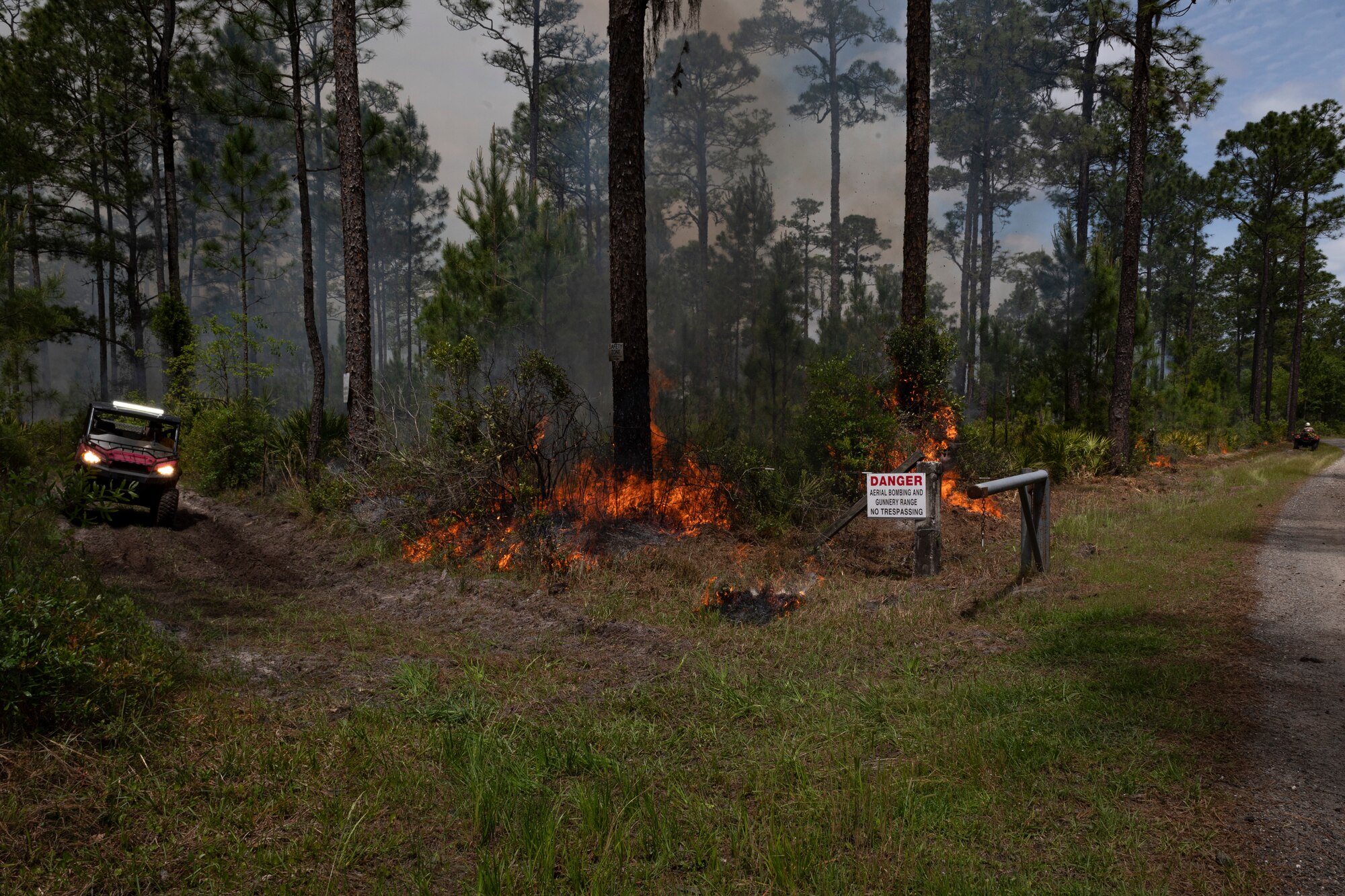 Photo of an Airman inspecting a fire