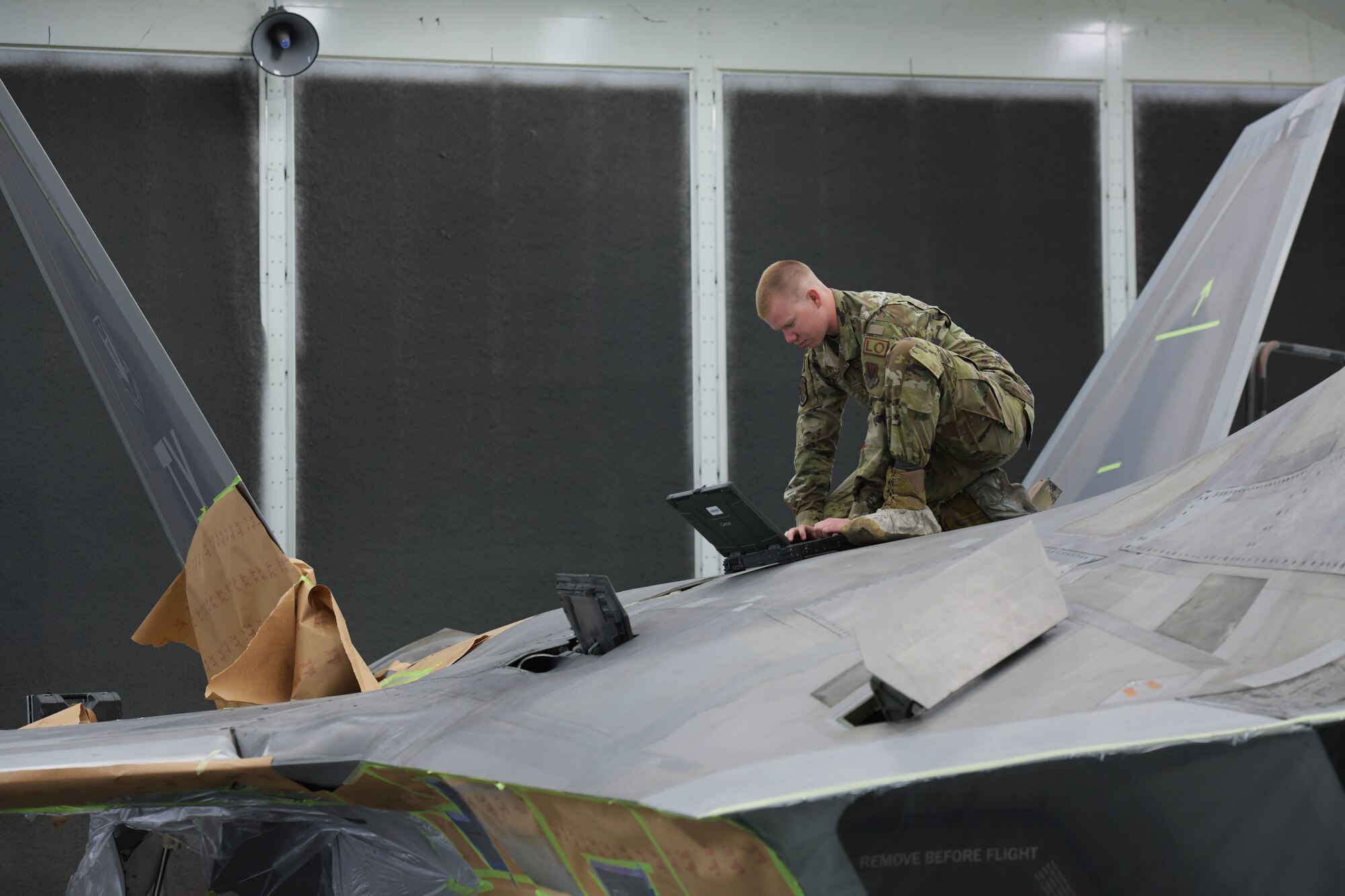U.S. Air Force Senior Airman William Kretzer, 325th Maintenance Squadron low observable journeyman, inspects an F-22 Raptor at Tyndall Air Force Base, Florida, March 28, 2022.