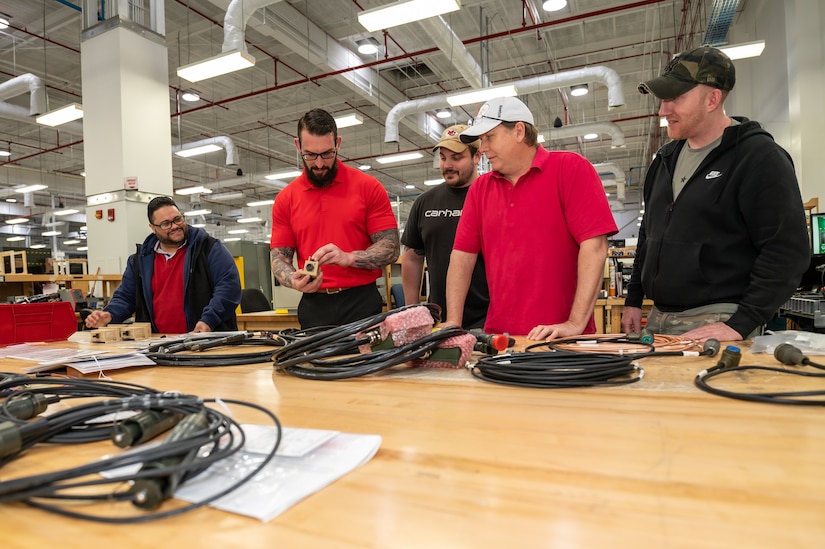 Photo of Jesse Tutino leading a hands-on discussion with his team.