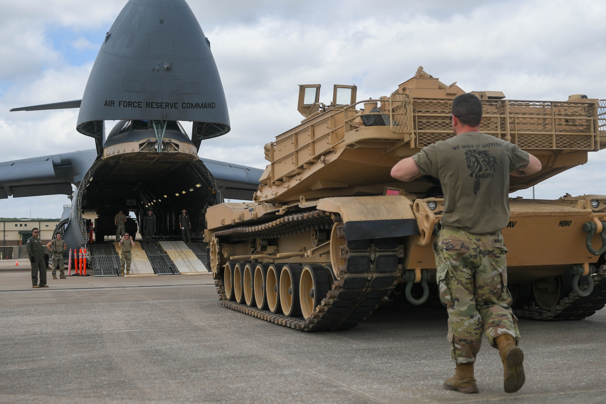 Tank crewmen assigned to the 1st Armored Brigade Combat Team, 1st Cavalry Division, guide an Abrams M1A2 System Enhancement Program Version 3 tank assigned to the 2nd Battalion, 12th Cavalry Regiment, onto a 433rd Airlift Wing C-5M Super Galaxy aircraft at Robert Gray Army Airfield, Fort Hood, Texas, April 20, 2022. The Abrams M1A2 SEPv3 was flown to Joint Base San Antonio-Randolph, Texas, to be displayed as part of The Great Texas Air Show, April 23-24, 2022.