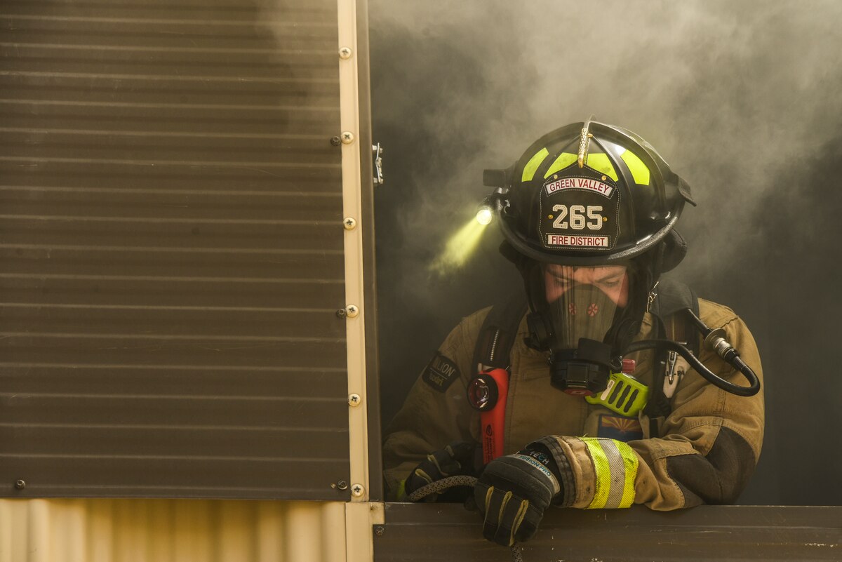 A photo of a firefighter clearing a building.