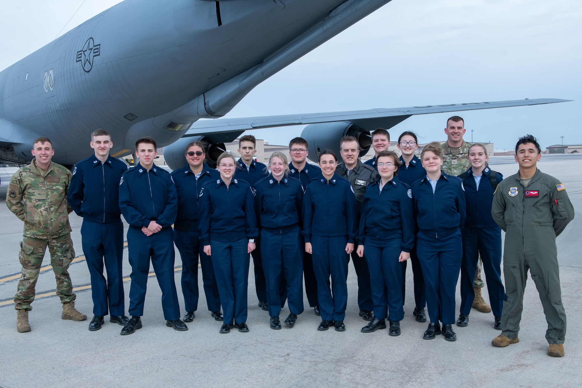 Students with the Douglas High School Air Force Junior Reserve Officer Training Corps (JROTC) pose for a group photo with active-duty Airmen on Ellsworth Air Force Base, S.D., April 19, 2022.  The JROTC students took the opportunity to ride a KC-135 Stratotanker during an airborne refueling exercise with B-1B Lancers. (U.S. Air Force Photo by Airman 1st Class Adam Olson)