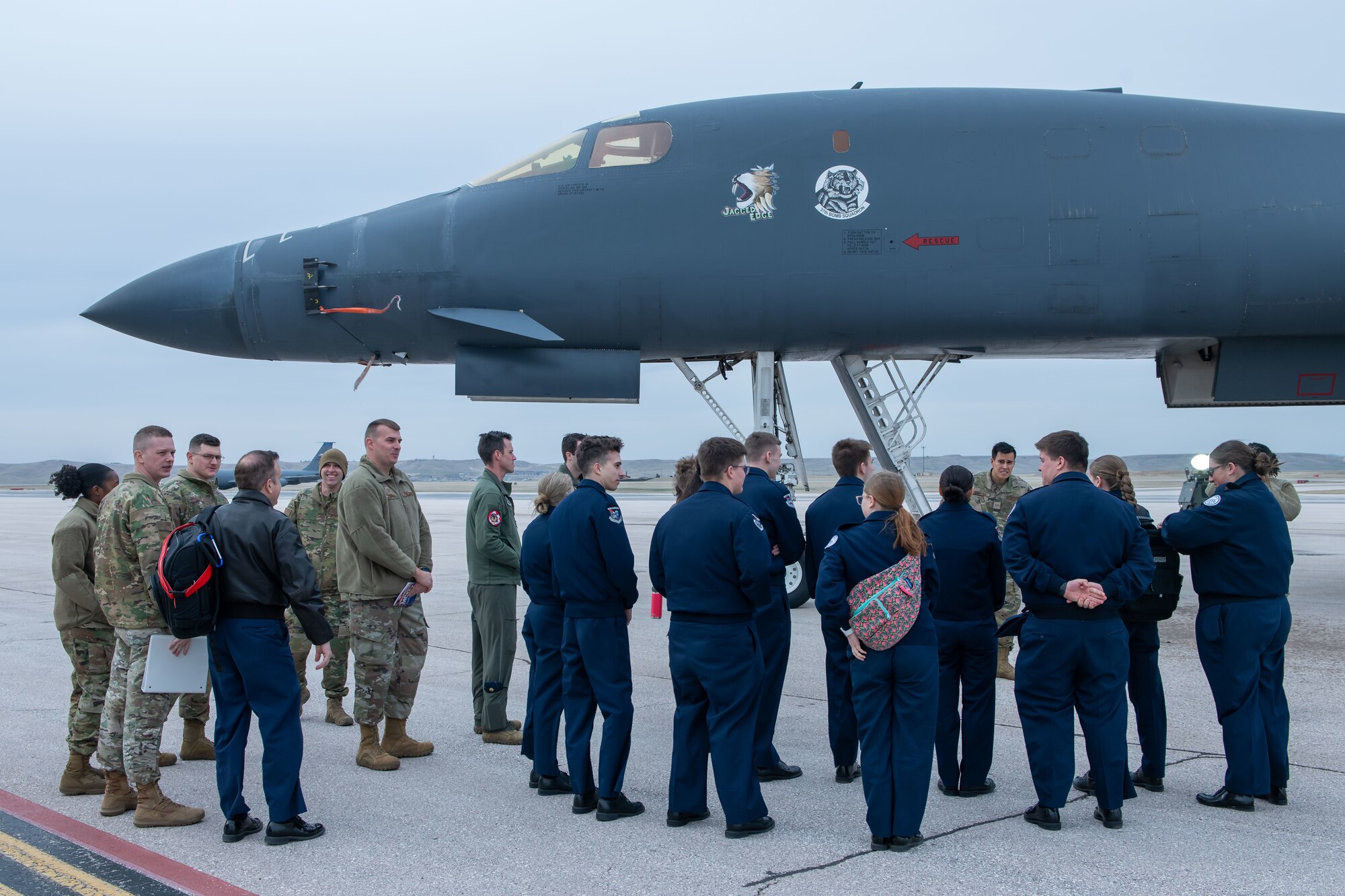 Students with the Douglas High School Air Force Junior Reserve Officer Training Corps visit a static display of a B-1B Lancer on Ellsworth Air Force Base, S.D., April 19, 2022. The pilots of Ellsworth were the first to utilize the Joint Air-to-Surface Standoff missile in a combat scenario. (U.S. Air Force Photo by Airman 1st Class Adam Olson)