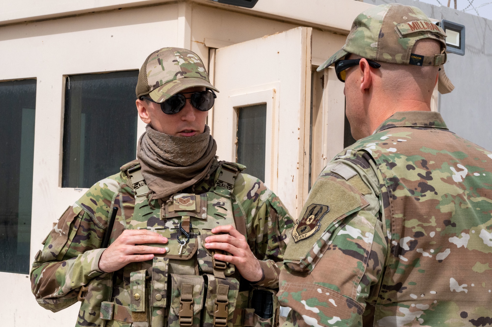 U.S. Air Force Staff Sgt. Terrance Lucero, 332d Expeditionary Security Forces Squadron response force member, talks with Chief Master Sgt. Sean M. Milligan, 332d Air Expeditionary Wing command chief, as Milligan visits 332nd Expeditionary Security Forces Squadron Airmen at an undisclosed location in Southwest Asia, April 23, 2022. Chief Milligan's immersion visits give him a better understanding of the unique skillsets every Airman brings to the 332d AEW Red Tail team. (U.S. Air Force photo by Tech. Sgt. Lauren M. Snyder)