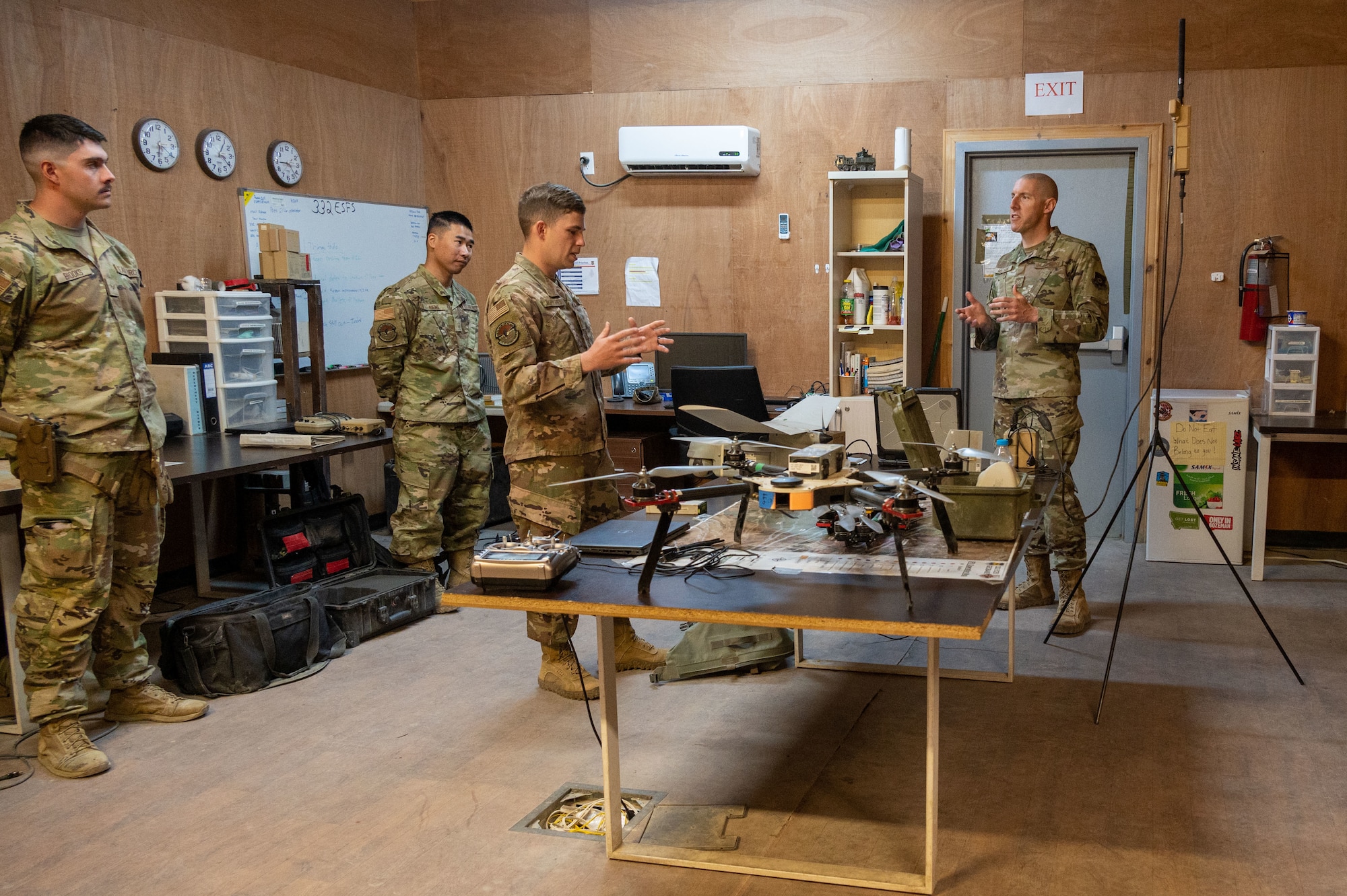 U.S. Air Force Chief Master Sgt. Sean M. Milligan, 332d Air Expeditionary Wing command chief, visits 332nd Expeditionary Security Forces Squadron Airmen in the combined defense operations center at an undisclosed location in Southwest Asia, April 23, 2022. Chief Milligan's immersion visits give him a better understanding of the unique skillsets every Airman brings to the 332d AEW Red Tail team. (U.S. Air Force photo by Tech. Sgt. Lauren M. Snyder)