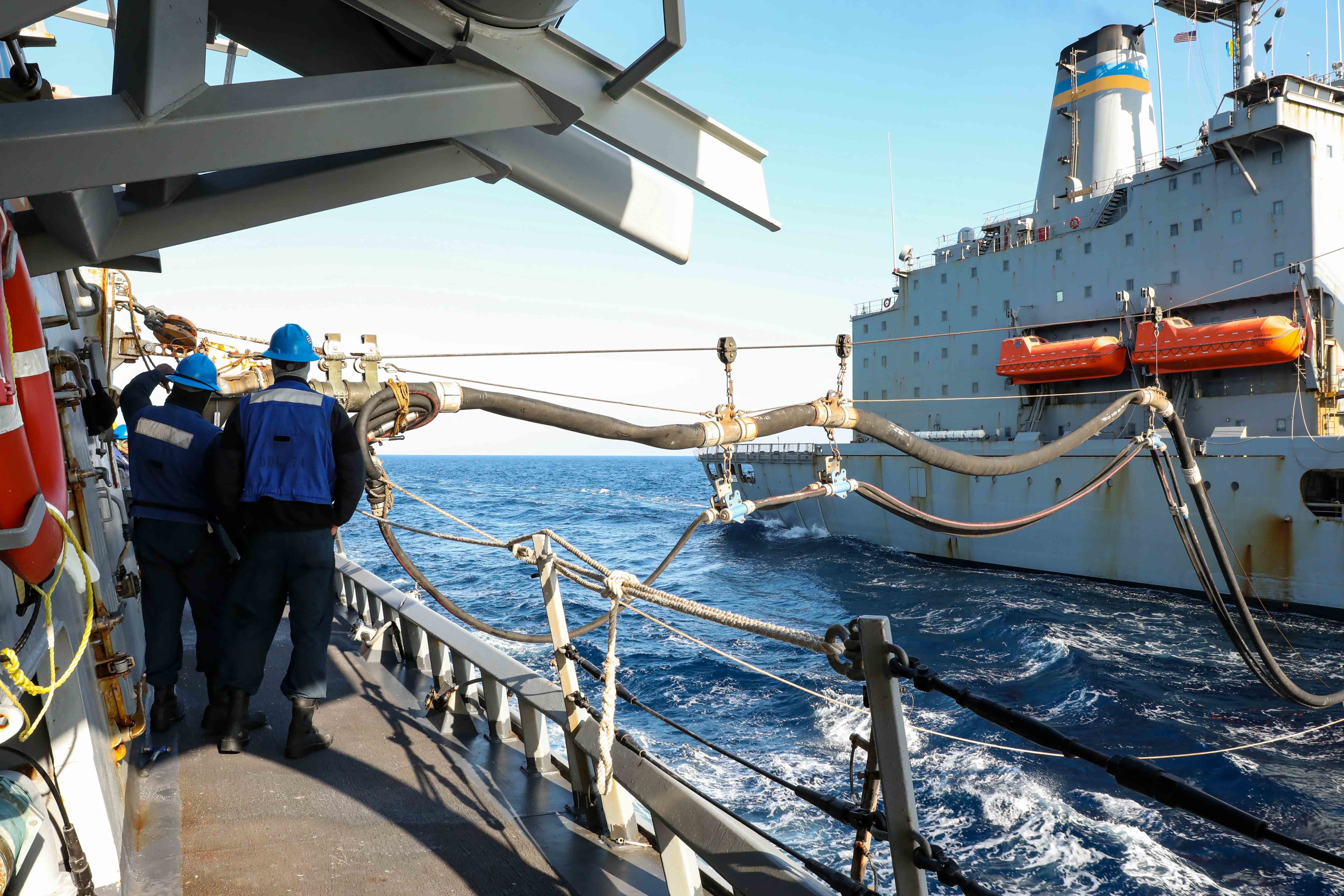 Sailors ensure a refueling probe is connected correctly during a replenishment-at-sea with the replenishment oiler USNS Laramie (T-AO 203), April 15, 2022.