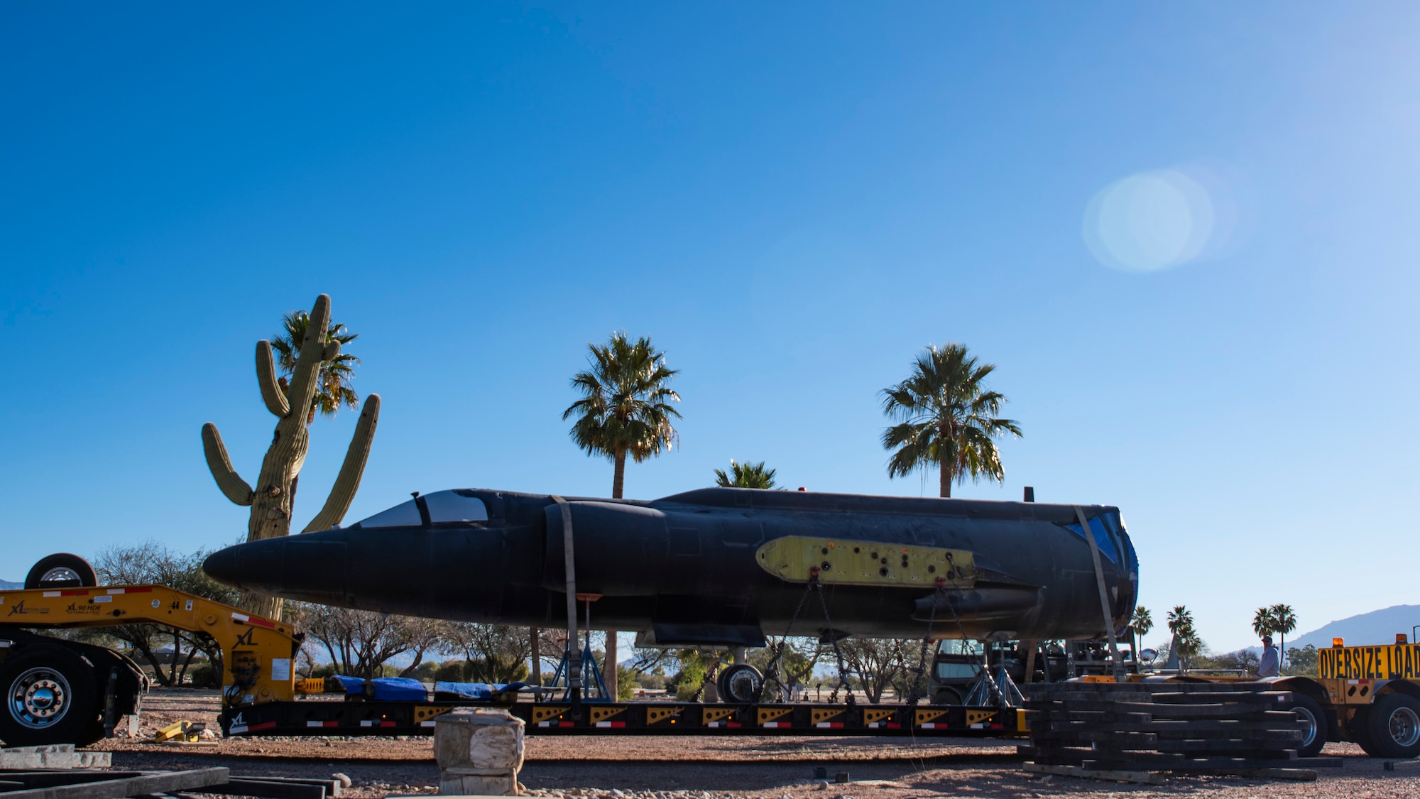 The body of an aircraft is secured on the back of a semitruck.