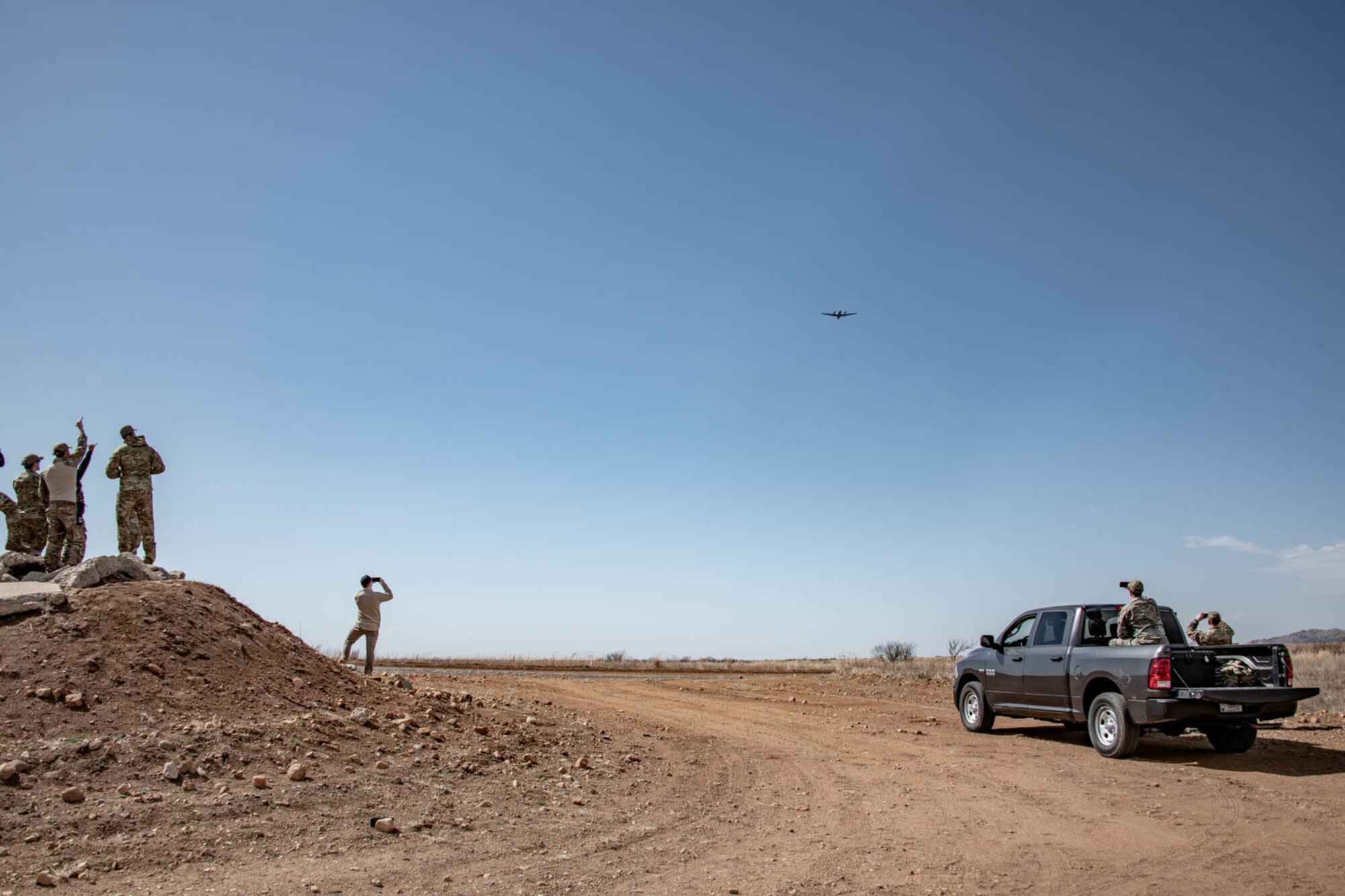 people on ground with plane in the air