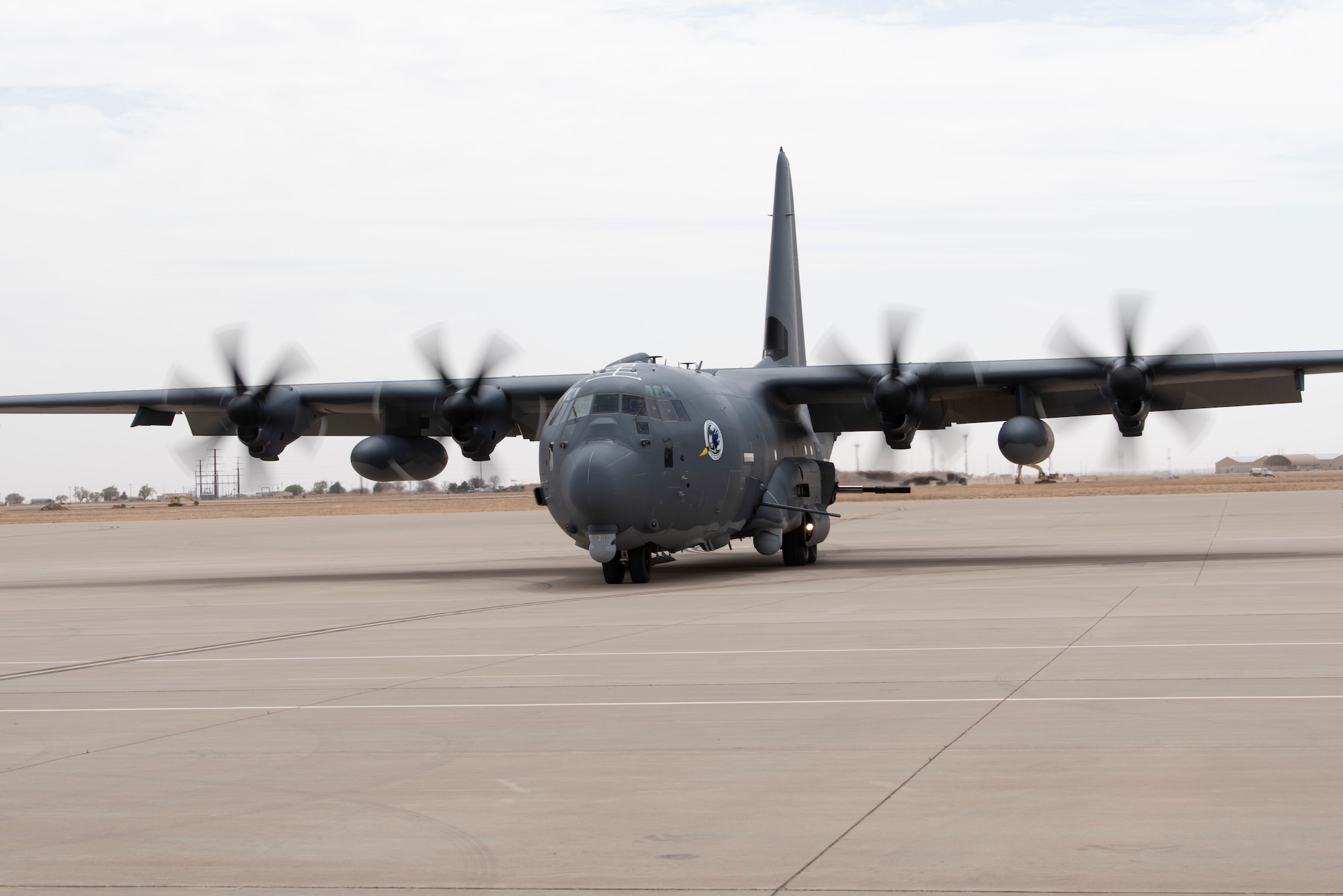A U.S. Air Force 16th Special Operations Squadron AC-130J Ghostrider arrives at Cannon Air Force Base, New Mexico, April 18, 2022. The arrival of the AC-130J Ghostrider represents a significant expansion of force generation capacity as the Air Force Special Operations Command structures for the reemergence of great power competition, demanding significant transformation to ensure Air Commandos are ready to successfully operate in full-spectrum operations. (U.S. Air Force photo by Airman 1st Class Cassidy Thomas) (This photo has been altered for security purposes by blurring out identification numbers and equipment)