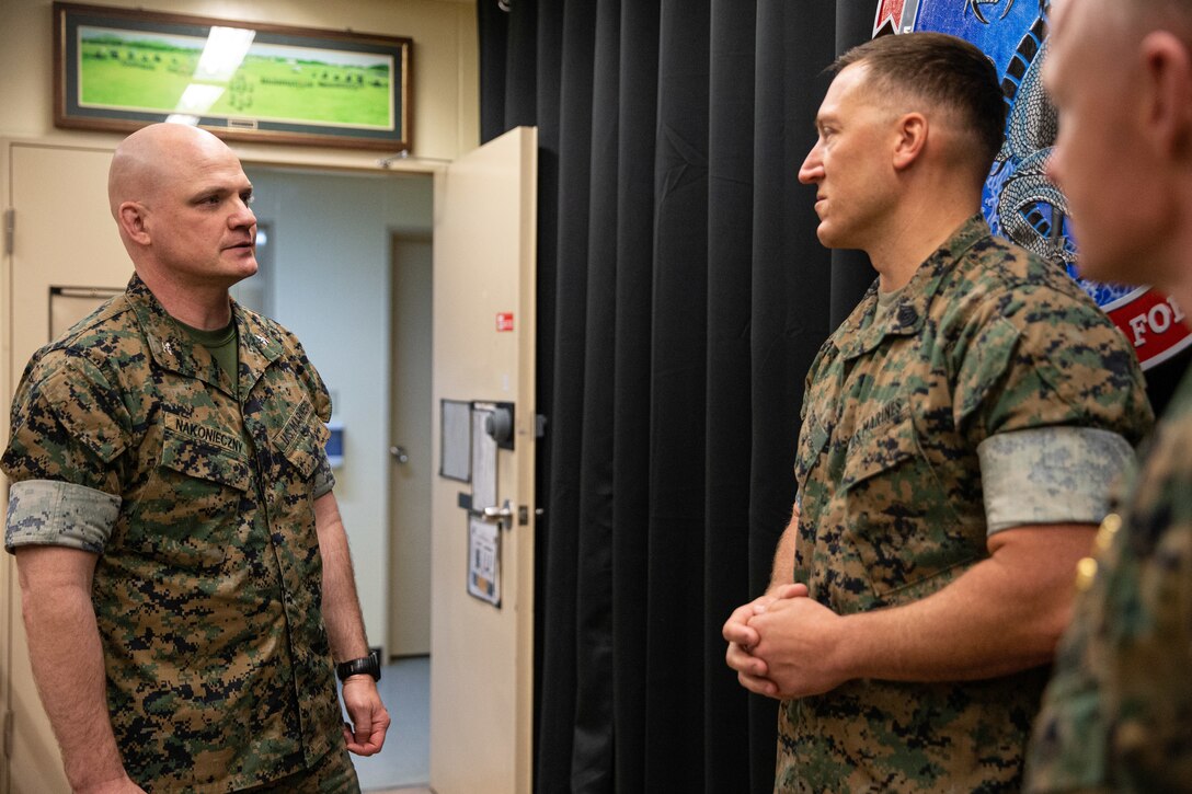 U.S. Marine Corps Col. Michael Nakoneczny, commanding officer of the 31st Marine Expeditionary Unit (MEU), congratulates Gunnery Sgt. Zachary Coe, a communications chief with the 31st MEU, for being selected for the Military Information Technology Leadership Award, Camp Hansen, Okinawa, Japan, 13 April, 2022. The Armed Forces Communications and Electronics Association Washing D.C., held the 15th annual Military Information Technology Leadership Awards. The AFCEA recognizes senior leaders from each branch that have made a significant contribution to the warfighting concept through the use of information technology. The 31st MEU, the Marine Corps' only continuously forward-deployed MEU, provides a flexible and lethal force ready to perform a wide range of military operations as the premier crisis response force in the Indo-Pacific region. (U.S. Marine Corps photo by Lance Cpl. Yvonne Iwae)