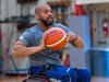 Retired U.S. Army Spc. Brent Garlic throws a basketball during a practice session on Fort Belvoir, Va, April 9, 2022. Team U.S. is a part of more than 500 participants from 20 countries who will take part in The Invictus Games The Hague 2020 featuring ten adaptive sports, including archery field, indoor rowing powerlifting, swimming, track, sitting, volleyball, wheelchair basketball, wheelchair rugby, and a driving challenge.