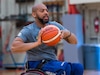 Retired U.S. Army Spc. Brent Garlic throws a basketball during a practice session on Fort Belvoir, Va, April 9, 2022. Team U.S. is a part of more than 500 participants from 20 countries who will take part in The Invictus Games The Hague 2020 featuring ten adaptive sports, including archery field, indoor rowing powerlifting, swimming, track, sitting, volleyball, wheelchair basketball, wheelchair rugby, and a driving challenge.