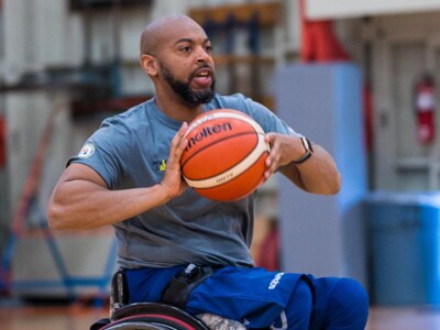 Retired U.S. Army Spc. Brent Garlic throws a basketball during a practice session on Fort Belvoir, Va, April 9, 2022. Team U.S. is a part of more than 500 participants from 20 countries who will take part in The Invictus Games The Hague 2020 featuring ten adaptive sports, including archery field, indoor rowing powerlifting, swimming, track, sitting, volleyball, wheelchair basketball, wheelchair rugby, and a driving challenge.