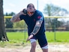Retired U.S. Army Staff Sgt Ross Alewine throws a shot putt during a practice session on Fort Belvoir, Virginia, on April 8, 2022. Team U.S. is a part of more than 500 participants from 20 countries who will take part in The Invictus Games The Hague 2020 featuring ten adaptive sports, including archery field, indoor rowing powerlifting, swimming, track, sitting, volleyball, wheelchair basketball, wheelchair rugby, and a driving challenge