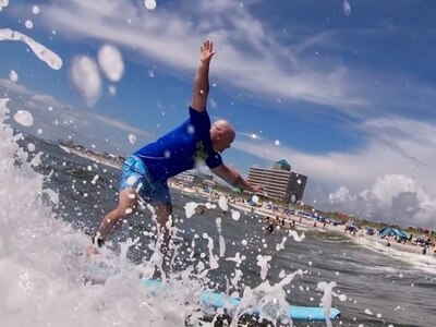 Staff Sgt. Judson Heard, a Soldier assigned to the Fort Bragg Soldier Recovery Unit, North Carolina, catches a wave at Carolina Beach on July 29 during an adaptive surfing event.