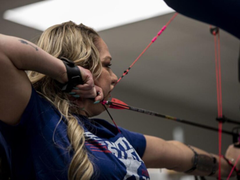 Retired U.S. Army Spc. Michelle, Sanchez, Team U.S., prepares to compete in the 2022 Invictus Games by training in archery during the 2022 Invictus Games Team U.S. Training Camp, Fort Belvoir, Virginia, April 10, 2022. Team U.S is a part of more than 500 participants from 20 countries who will take part in The Invictus Games The Hague 2020 featuring ten adaptive sports, including archery, field, indoor rowing, powerlifting, swimming, track, sitting volleyball, wheelchair basketball, wheelchair ruby, and a driving challenge.