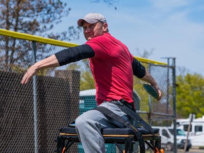 Retired Sergeant 1st Class Josh Olson throwing a discus during a practice session on Fort Belvoir, Virginia, April 11, 2022. Team U.S. is a part of more than 500 participants from 20 countries who will take part in The Invictus Games The Hague 2020 featuring ten adaptive sports, including archery field, indoor rowing powerlifting, swimming, track, sitting, volleyball, wheelchair basketball, wheelchair rugby, and a driving challenge.