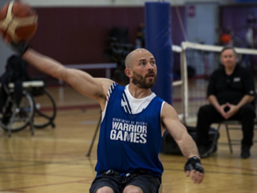 Retired U.S. Staff Sgt. Shawn Runnells , Team U.S., trains for wheelchair basketball practice, during the Invictus Games Team U.S. Training Camp at Fort Belvoir, Virginia on April 11, 2022. Team U.S. is part of more than 500 participants from 20 countries who will take part in this multi-sport event featuring ten adaptive sports, including archery, field, indoor rowing, powerlifting, swimming, track, sitting volleyball, wheelchair basketball, wheelchair rugby, and a driving challenge.