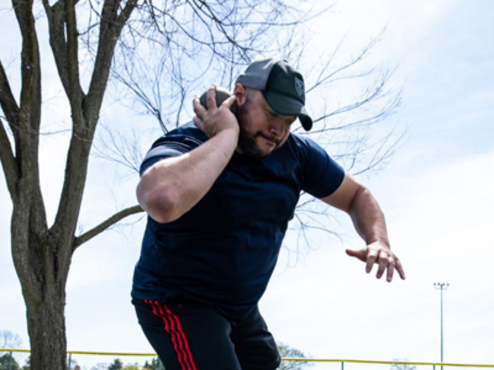Retired U.S. Army Capt. Alex Wilson prepares to compete in the 2022 Invictus Games by training in shot put during the 2022 Invictus Games Team U.S. Training Camp, Fort Belvoir, Virginia, April 11, 2022. Team U.S is a part of more than 500 participants from 20 countries who will take part in The Invictus Games The Hague 2020 featuring ten adaptive sports, including archery, field, indoor rowing, powerlifting, swimming, track, sitting volleyball, wheelchair basketball, wheelchair ruby, and a driving challenge.