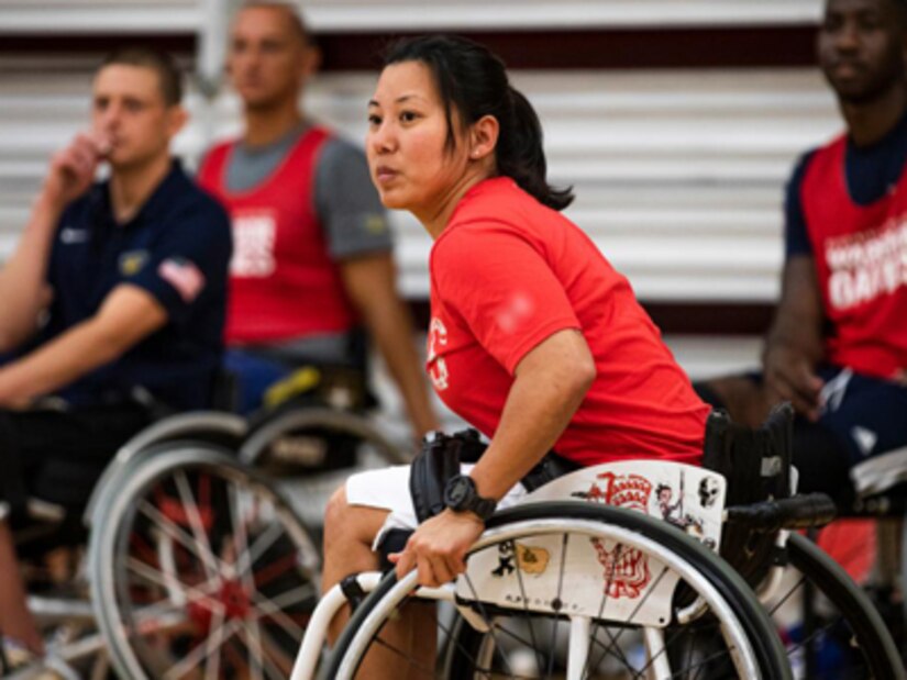 Retired U.S. Army Staff Sgt. Hyoshin "Gabi" Cha prepares to compete in the Invictus Games, held in the Netherlands, by training in wheelchair basketball at the 2022 Invictus Games Team U.S. Training Camp, Fort Belvoir, Virginia, April 9, 2022. Team U.S is a part of more than 500 participants from 20 countries who will take part in The Invictus Games The Hague 2020 featuring ten adaptive sports, including archery, field, indoor rowing, powerlifting, swimming, track, sitting volleyball, wheelchair basketball, wheelchair rugby, and a driving challenge.