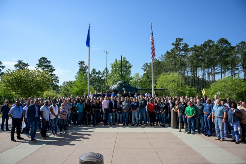 Members of U.S. Army Central gather in front of Patton Hall wearing jeans in support of Denim Day.