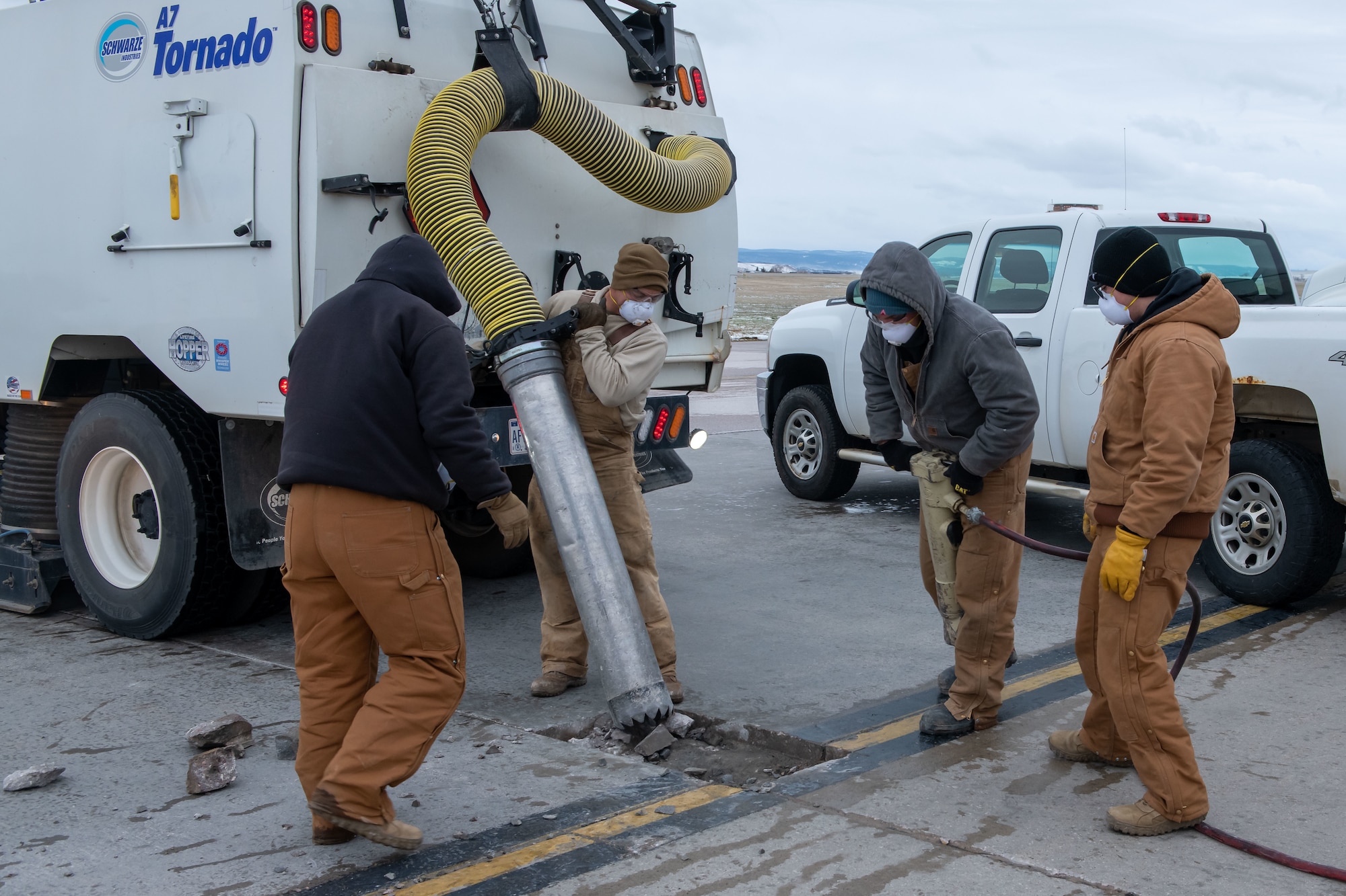 Airmen with the 28th Civil Engineering Squadron Dirt Boyz remove a piece of the flight line on Ellsworth Air Force Base, S.D., April 24, 2022. Major damage or blemishes on the flight line must be removed entirely and then concrete will be repoured to fill the void. (U.S. Air Force photo by Airman 1st Class Adam Olson)