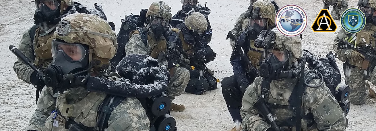 Soldiers wear the M53A1 respirator with the ST-54 Self Contained Breathing Apparatus (SCBA) and Combination System Powered Air Purifying Respirator (CS-PAPR) during an exercise.