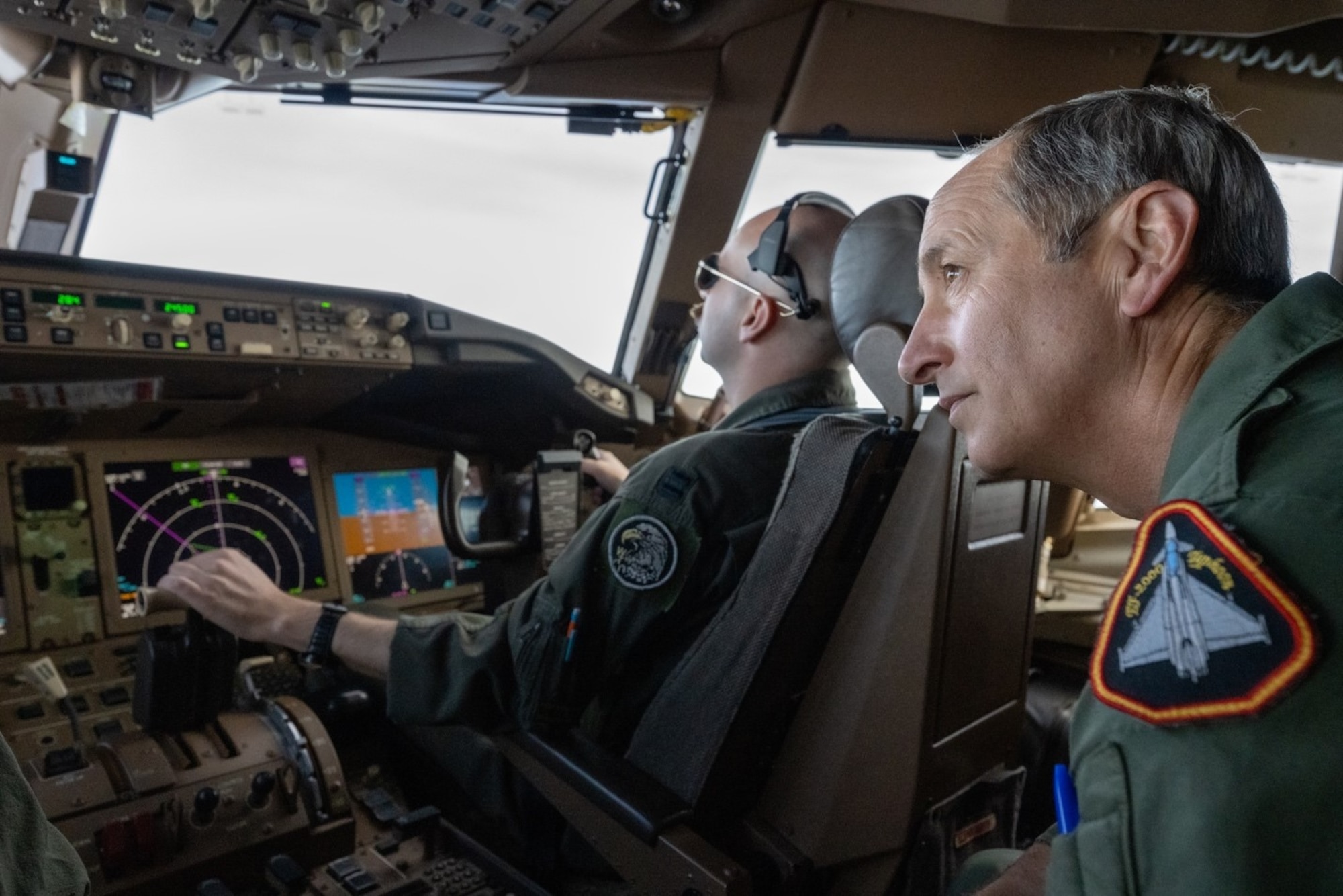 Morón Air Base commander, Spanish Air Force Col. Enrique Fernandez Ambel, observes as U.S. Air Force Capt. Steven Strickland, 344th Air Refueling Squadron KC-46A Pegasus instructor pilot, approaches to receive fuel during an orientation flight April 18, 2022. Spanish commanders joined the flight to familiarize themselves with U.S. tanker operations and witness the first-ever Pegasus refueling of an international aircraft, a Spanish EF-18 Hornet, also known in Spain as a C-15. (U.S. Air Force photo by Staff Sgt. Nathan Eckert)