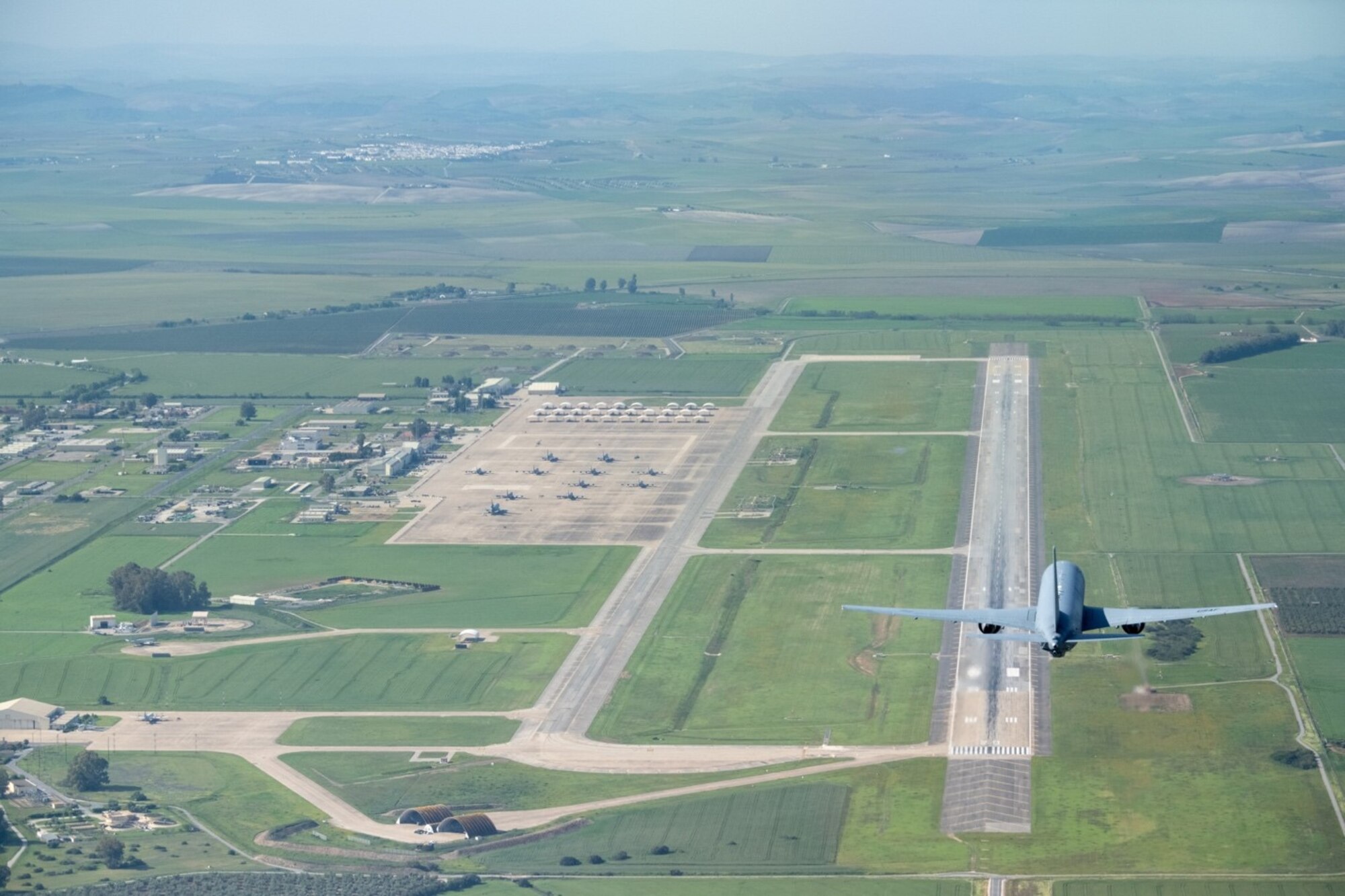 A KC-46A Pegasus from McConnell Air Force Base, Kansas, begins an overpass before landing at Morón Air Base, Spain, April 18, 2022. The aircraft participated in the first KC-46 Employment Concept Exercise, ECE22-03,  an Air Mobility Command effort to evaluate the aircraft’s ability to provide rapid global mobility capacity to future joint force operations in a contingency-like environment. (U.S. Air Force photo by Staff Sgt. Nathan Eckert)