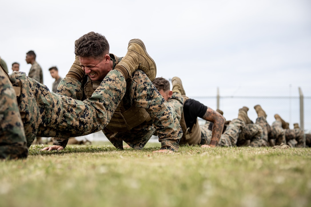 U.S. Marines participate in a squad pushups event as part of a Martial Arts Instructor course at Camp Kinser, Okinawa, Japan, April 22. The Marines participated in the 15-day MAI course to become instructors and gain the ability to train and advance Marines in the Marine Corps Martial Arts Program.