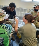 Wisconsin Army National Guard Spc. Samantha Struck demonstrates how to insert an IV during a medical class with the Papua New Guinea Defense Force at Taurama Barracks, Port Moresby, Papua New Guinea, in March 2022 through the Department of Defense National Guard State Partnership Program.