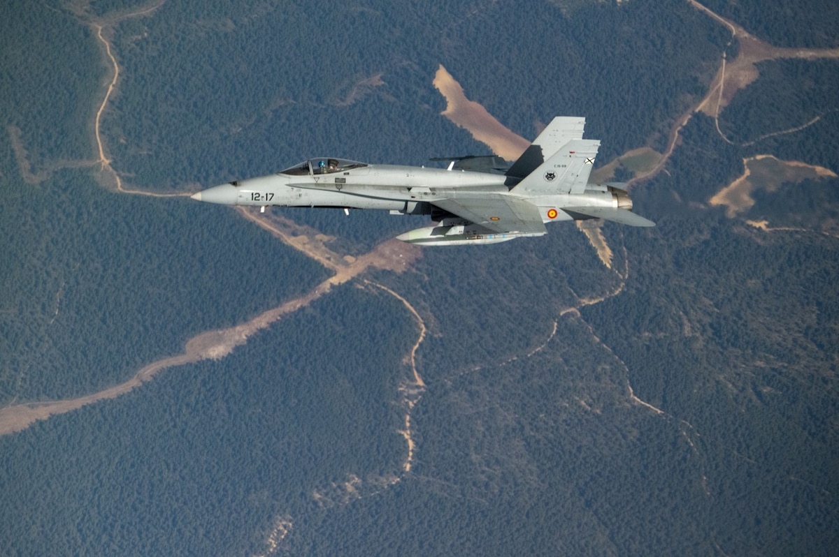A Spanish Air Force EF-18 Hornet, known in Spain as a C-15, from Torrejón Air Base, Spain, pulls away after refueling from a U.S. Air Force KC-46A Pegasus based at McConnell Air Force Base, Kansas, April 18, 2022. The Spanish fighter is the first international aircraft to be refueled by the Pegasus. McConnell’s aircrew and four KC-46As were in Spain for the aircraft’s first Employment Concept Exercise, ECE 22-03, which is designed to further operational testing and evaluation, increase proficiency among aircrews and support personnel, and strengthen aircraft sustainment operations. (U.S. Air Force photo by Staff Sgt. Nathan Eckert)