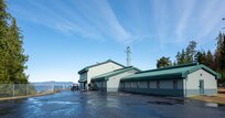 Building 1 of Naval Surface Warfare Center, Carderock Division’s Southeast Alaska Acoustic Measurement Facility on a sunny day in Back Island, Alaska.