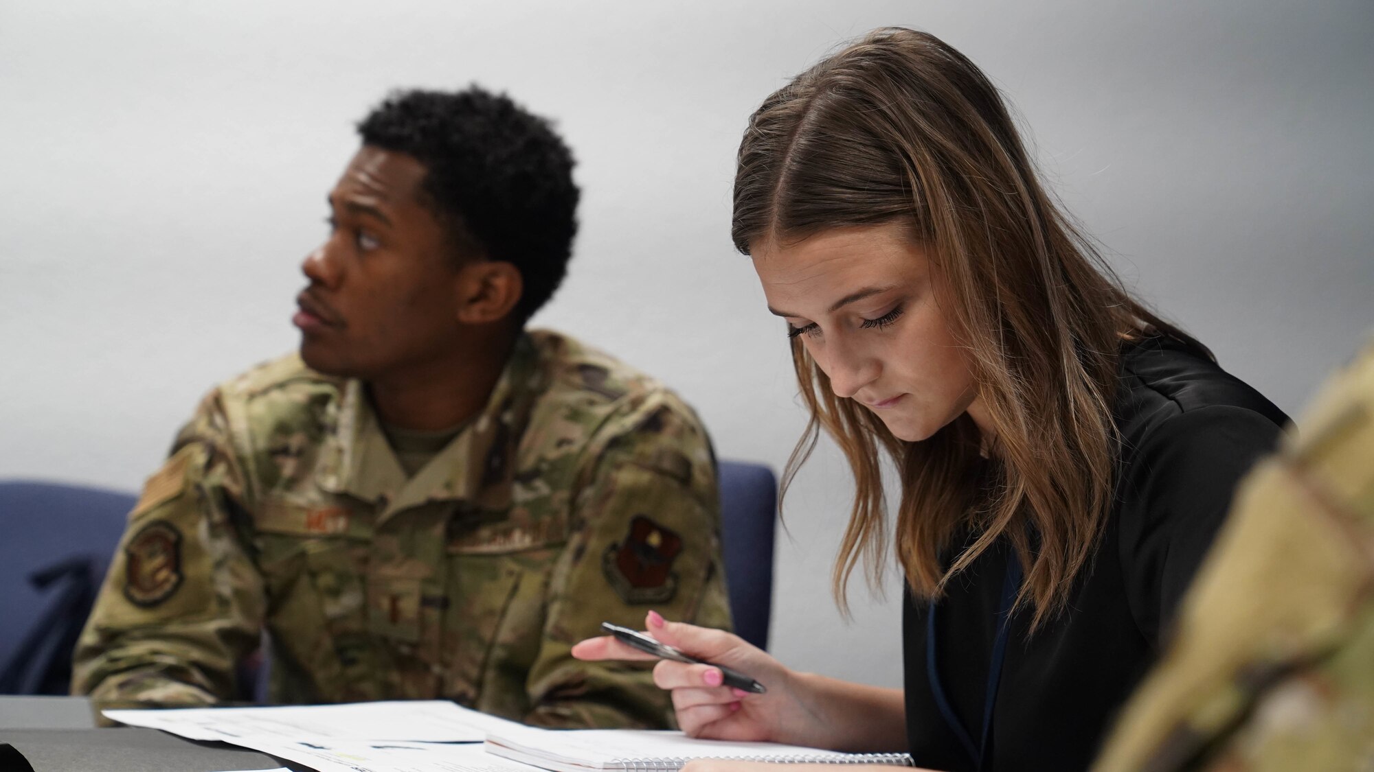 Brooke Geigenmiller and U.S. Air Force 2nd Lt. Phillip Mott, 81st Contracting Squadron members, examine a contract during the 81st CONS roadshow at Keesler Air Force Base, Mississippi, April 20, 2022. Members of the 81st CONS created the roadshow to improve processes and address an information gap between their staff and Keesler’s various units. (U.S. Air Force photo by Airman 1st Class Elizabeth Davis)