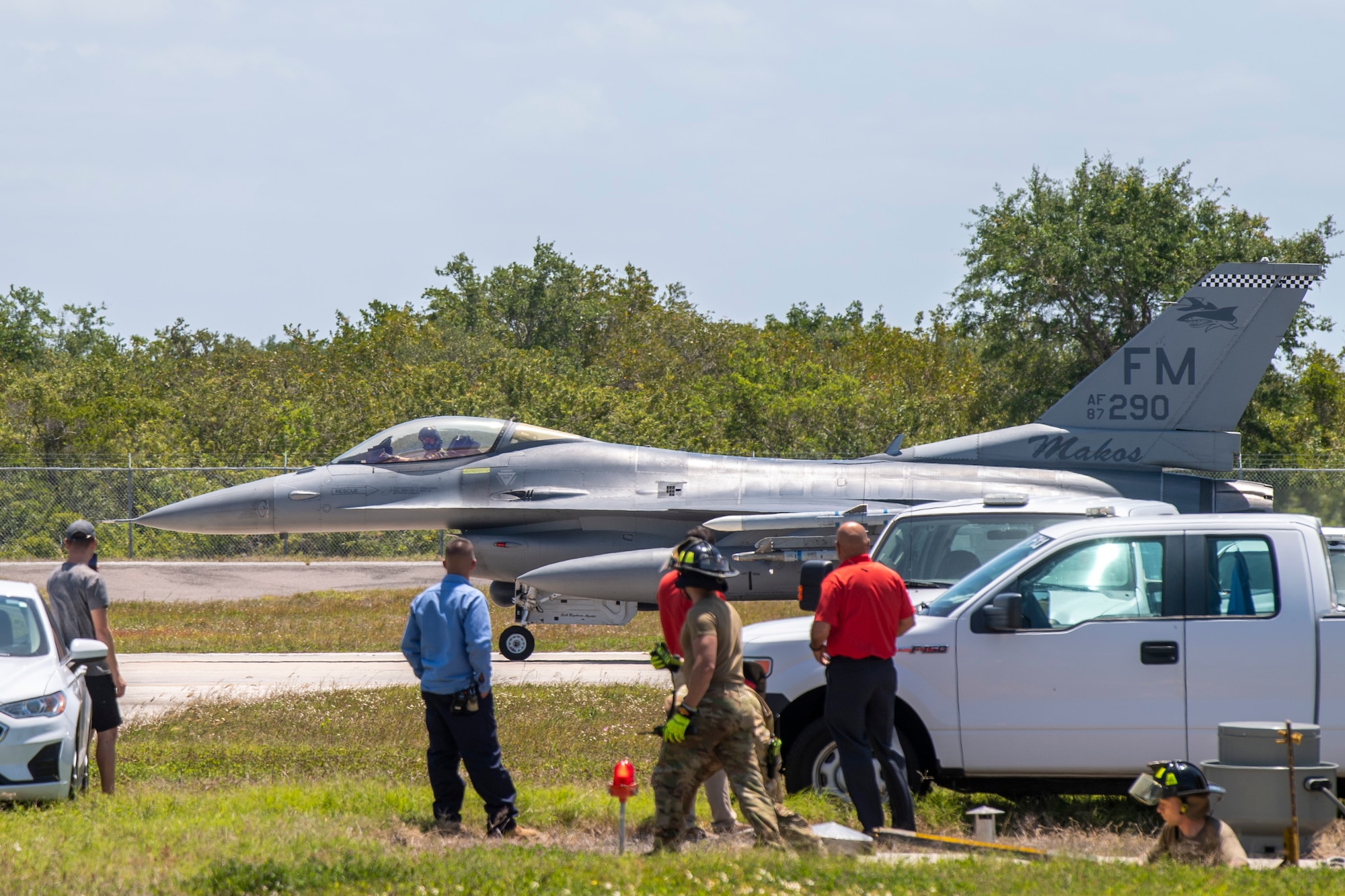 An F-16C Fighting Falcon from the 482nd Fighter Wing, Homestead Air Reserve Base, Florida, taxis past Airmen from the 6th Civil Engineer Squadron at MacDill Air Force Base, Florida (AFB), April 22, 2022.