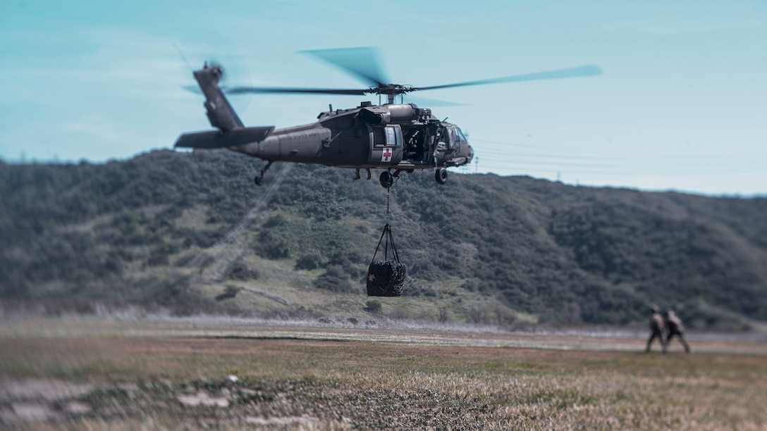 A U.S. Army UH-60 Black Hawk, assigned to Golf Company, 7th Battalion, 158th Aviation Regiment, lifts tires during a Helicopter Support Team training event