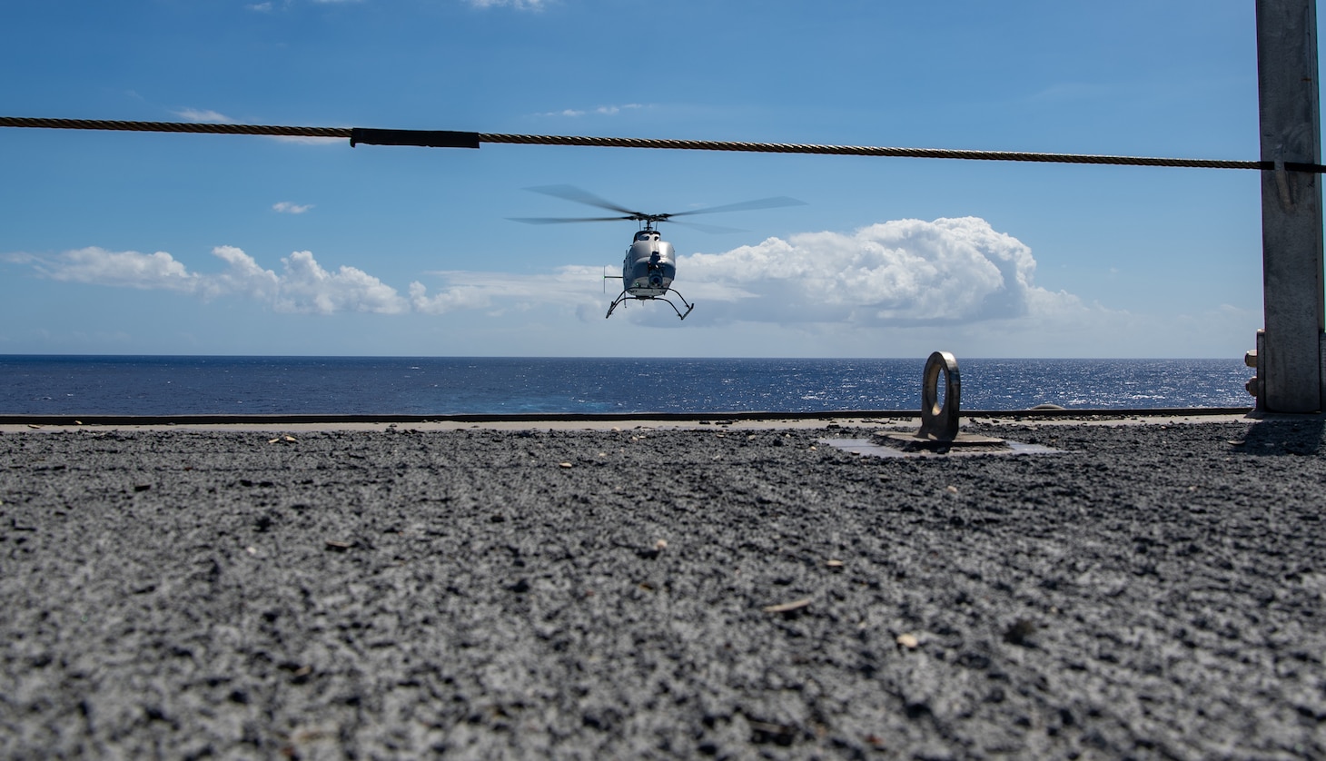 220419-N-JX182-1037 PHILLIPINE SEA (April 19, 2022) An MQ-8C Fire Scout, attached to the “Wildcards” of Helicopter Sea Combat (HSC) Squadron 23, assigned to the Independence-variant littoral combat ship USS Jackson (LCS 6), prepares to land aboard Jackson. Jackson, part of Destroyer Squadron (DESRON) 7, is on a rotational deployment, operating in the U.S. 7th Fleet area of operations to enhance interoperability with partners and serve as a ready-response force in support of a free and open Indo-Pacific region. (U.S. Navy photo by Mass Communication Specialist 3rd Class Charles DeParlier)