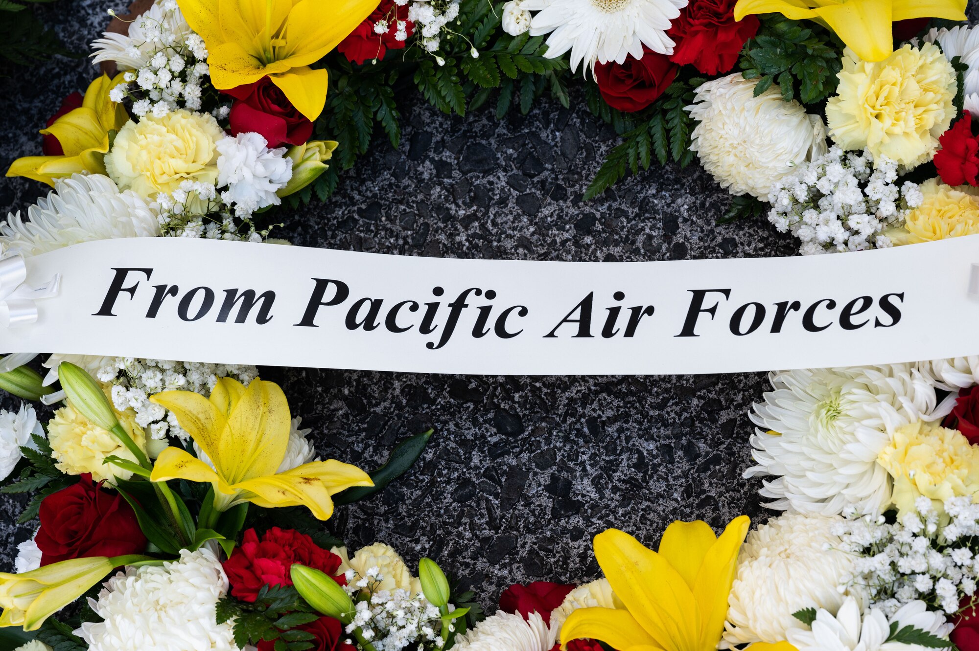 A wreath is laid by Pacific Air Forces Commander, U.S. Air Force Gen. Ken Wilsbach, and Cindy Wilsbach, First Lady of PACAF, in honor of Anzac, or Australian and New Zealand Army Corps, Day at the National Memorial Cemetery of the Pacific, Honolulu, Hawaii, April 25, 2022. The wearing of small sprigs of rosemary or red poppies signifies remembrance and commemoration of those who died while serving their county. (U.S. Air Force photo by Tech. Sgt. Hailey Haux)