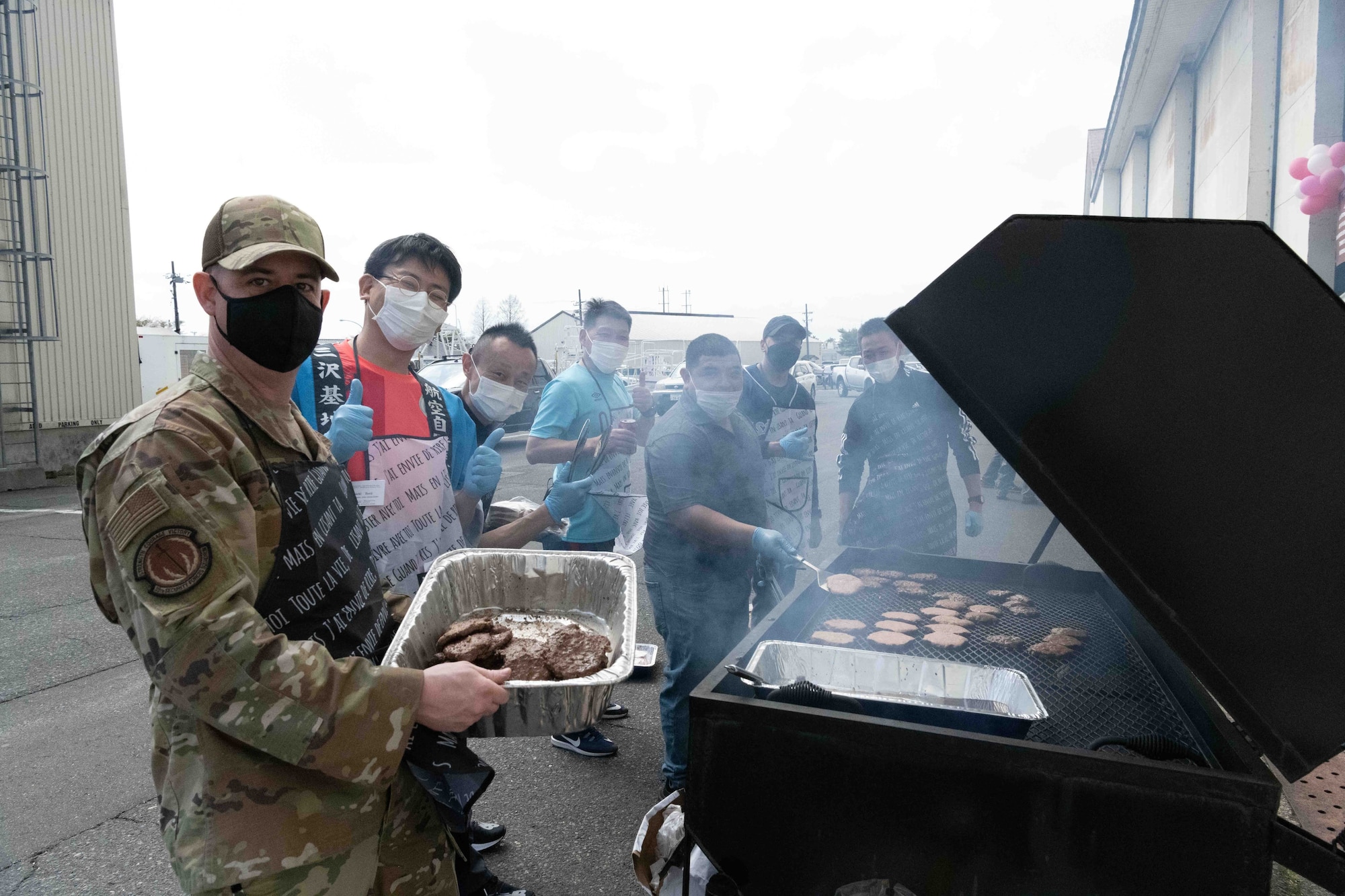 Team Misawa members pose for a photo while grilling burgers at the award ceremony.