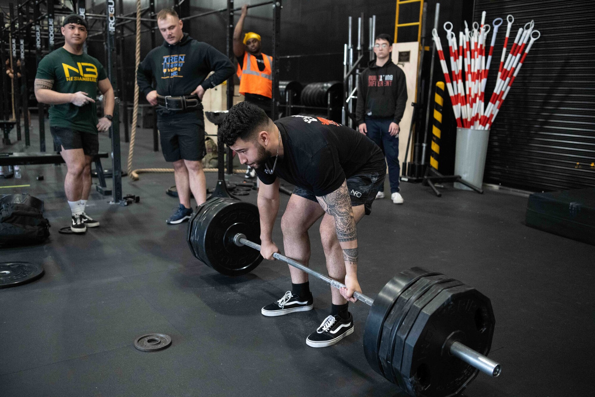 Participant prepares to deadlift a barbell during a power lifting competition.