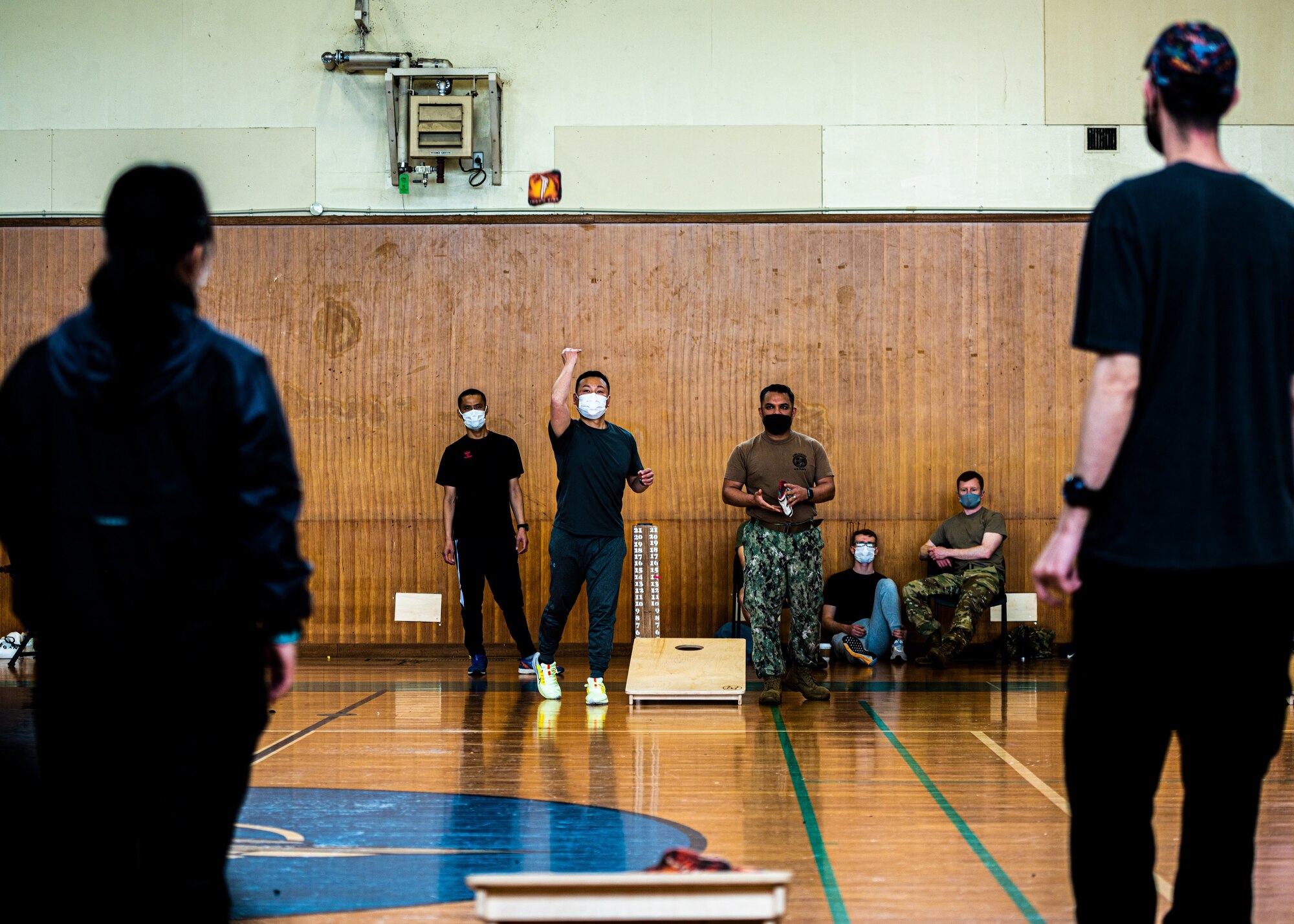 Member from Misawa Air base tossing a bean bag during a game of cornhole.